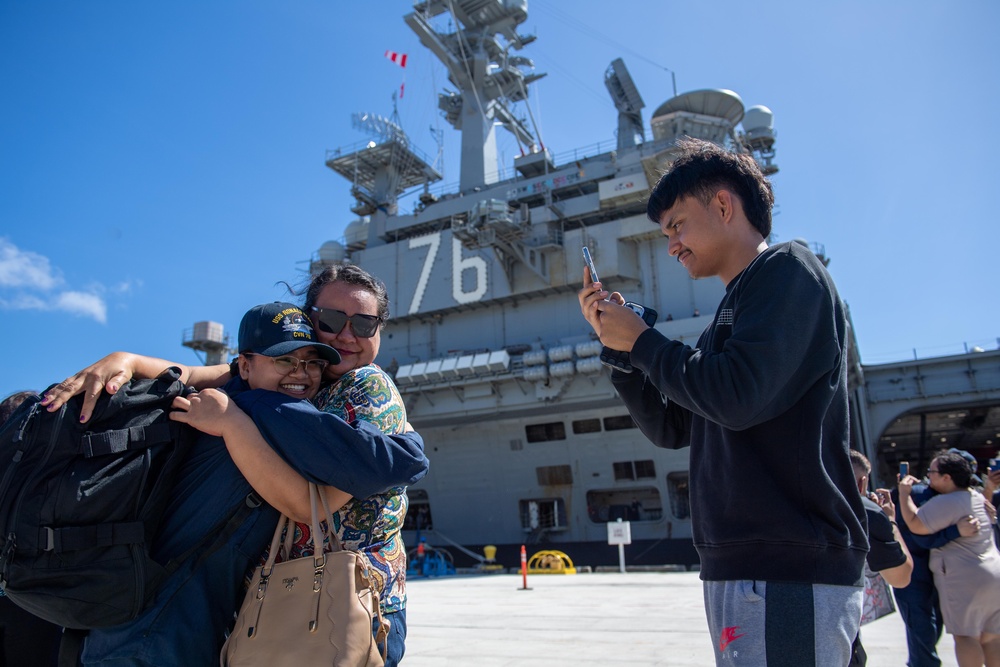 USS Ronald Reagan (CVN 76) Sailors greet family on the pier after arriving at Naval Base Guam for scheduled port visit