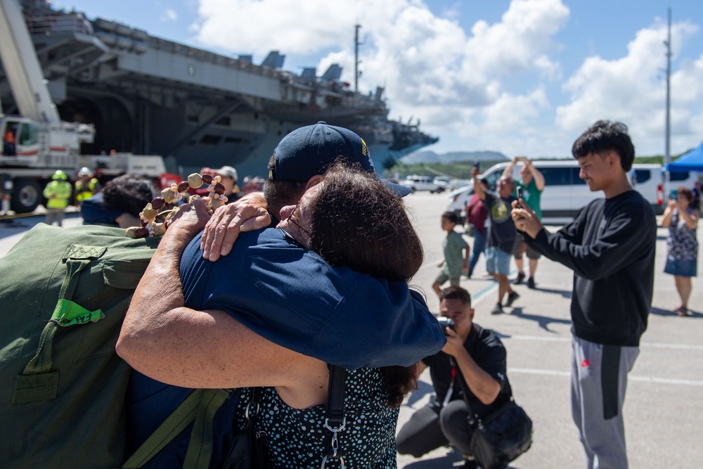 USS Ronald Reagan (CVN 76) Sailors greet family on the pier after arriving at Naval Base Guam for scheduled port visit