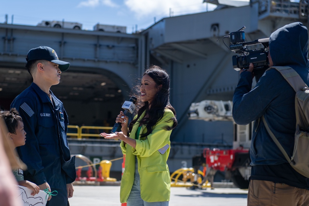 USS Ronald Reagan (CVN 76) Sailors greet family on the pier after arriving at Naval Base Guam for scheduled port visit