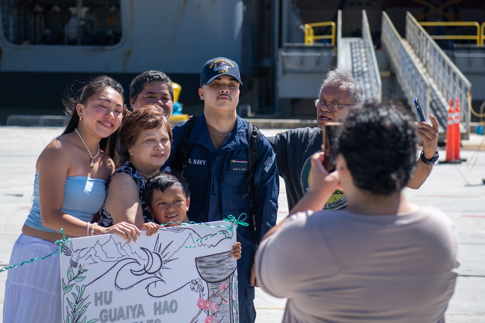 USS Ronald Reagan (CVN 76) Sailors greet family on the pier after arriving at Naval Base Guam for scheduled port visit