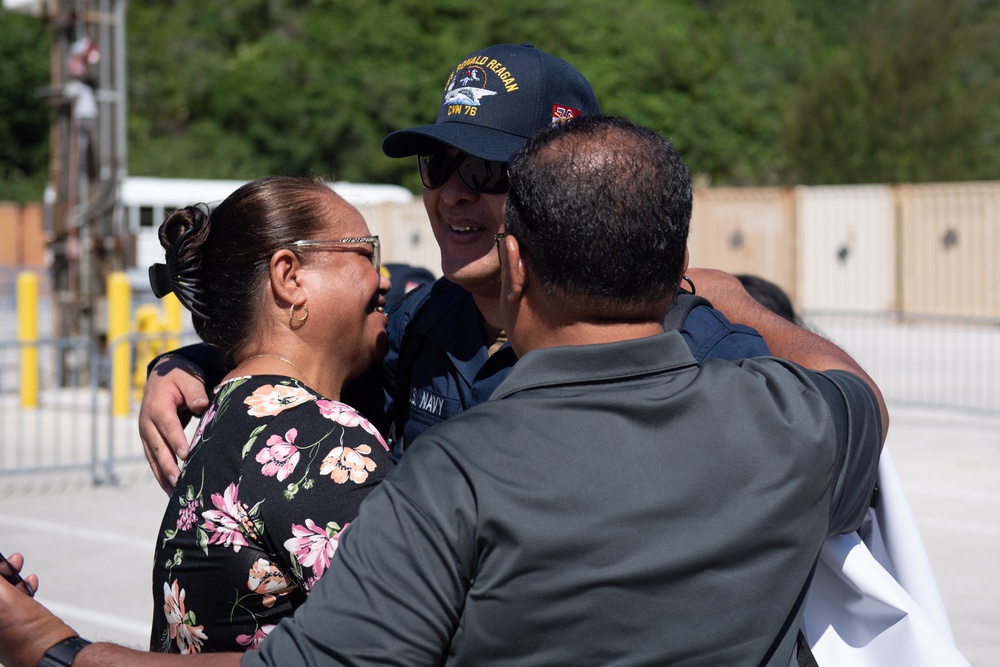 USS Ronald Reagan (CVN 76) Sailors greet family on the pier after arriving at Naval Base Guam for scheduled port visit