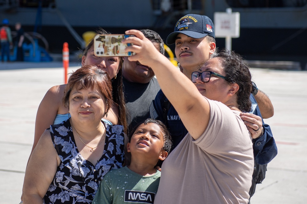 USS Ronald Reagan (CVN 76) Sailors greet family on the pier after arriving at Naval Base Guam for scheduled port visit