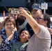 USS Ronald Reagan (CVN 76) Sailors greet family on the pier after arriving at Naval Base Guam for scheduled port visit