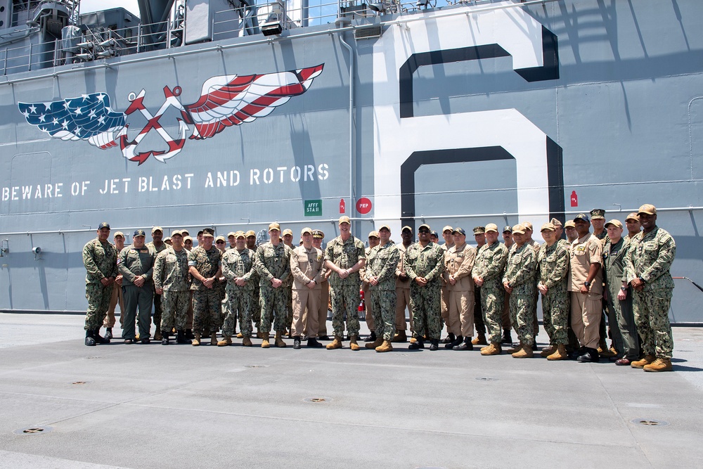 Task Force 76 Commander’s Conference attendees assemble for a group photo aboard the forward-deployed amphibious assault ship USS America (LHA 6)