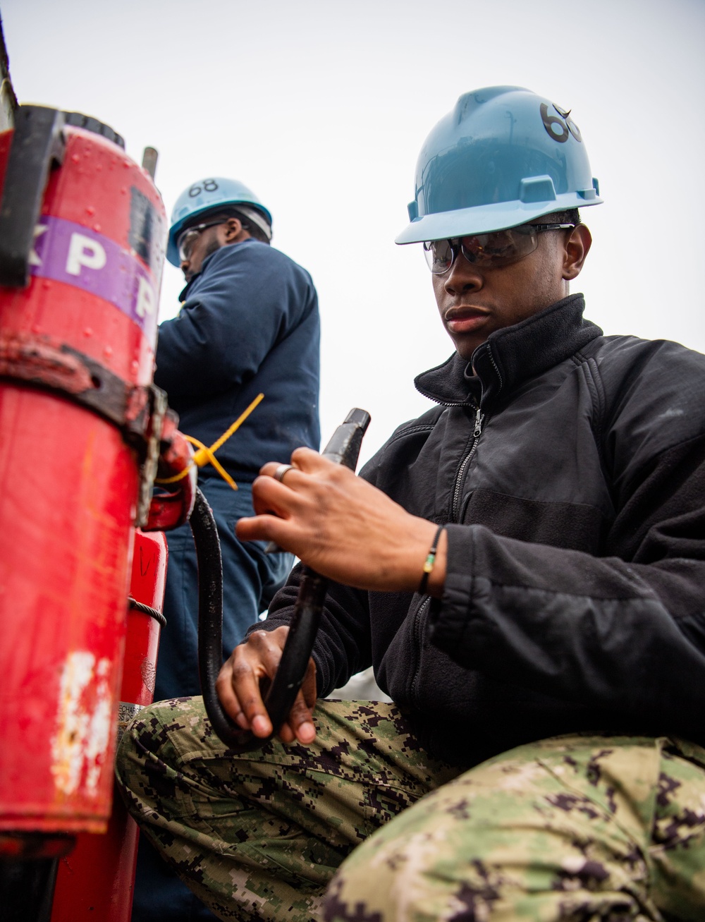 Sailor Does Maintenance On PKP Bottle