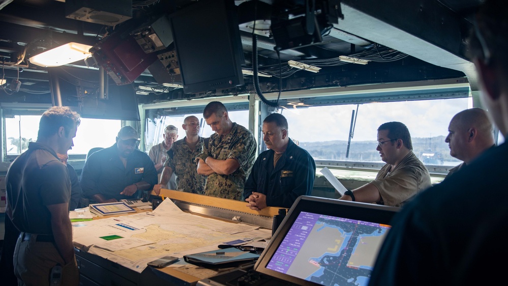 ESL Sailors and Military Sealift Command civil service mariners discuss navigation operations on the bridge