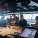 ESL Sailors and Military Sealift Command civil service mariners discuss navigation operations on the bridge