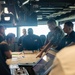 ESL Sailors and Military Sealift Command civil service mariners discuss navigation operations on the bridge