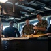 ESL Sailors and Military Sealift Command civil service mariners discuss navigation operations on the bridge