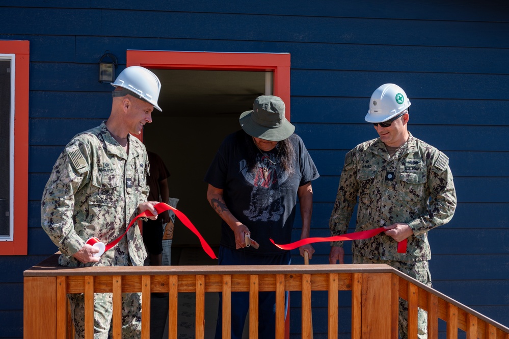 Alvin Malone cuts the ribbon on his new home.