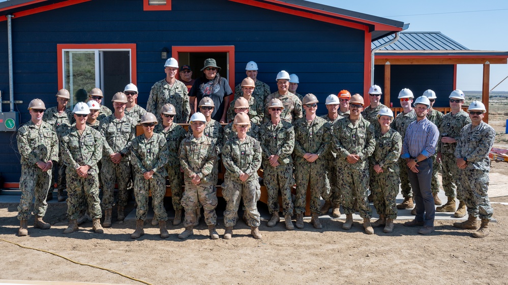 U.S. Navy and U.S. Air Force pose for group photo with the Malones.