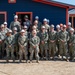 U.S. Navy and U.S. Air Force pose for group photo with the Malones.