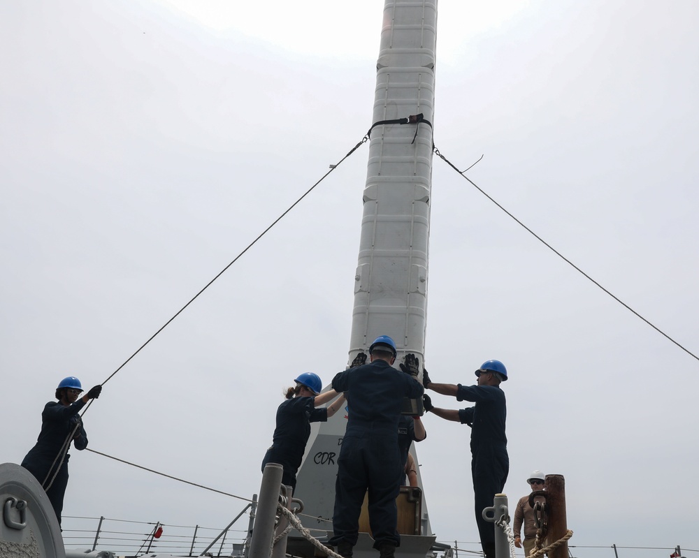 Sailors aboard the USS Howard conduct a missile onload in Yokosuka, Japan