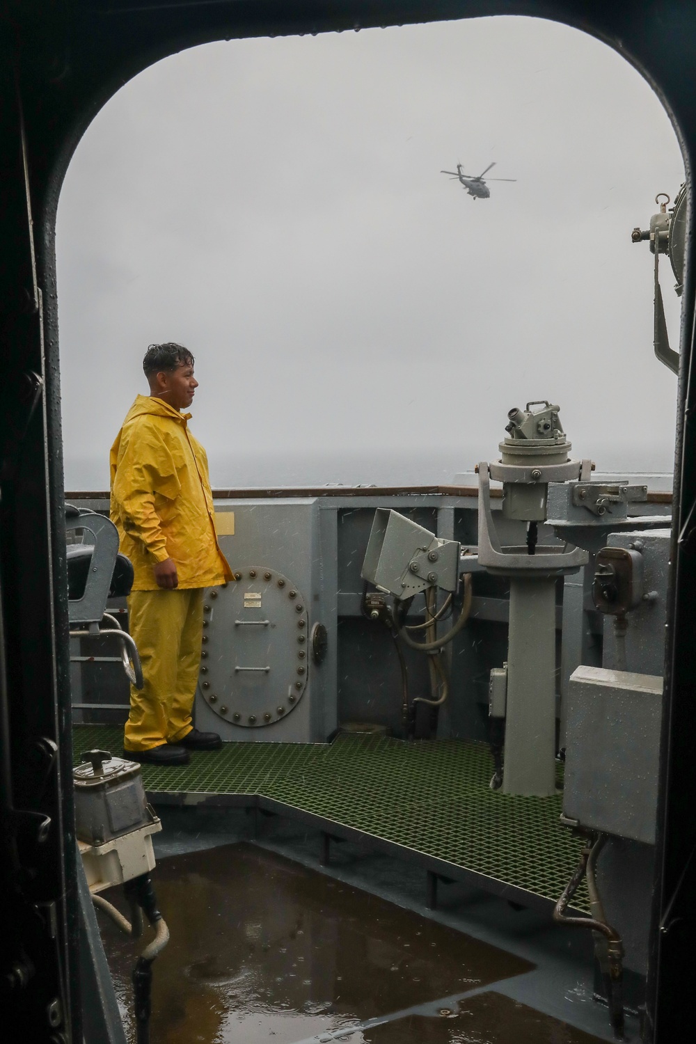 Sailors aboard the USS Howard stand watch on the bridge in the Pacific Ocean
