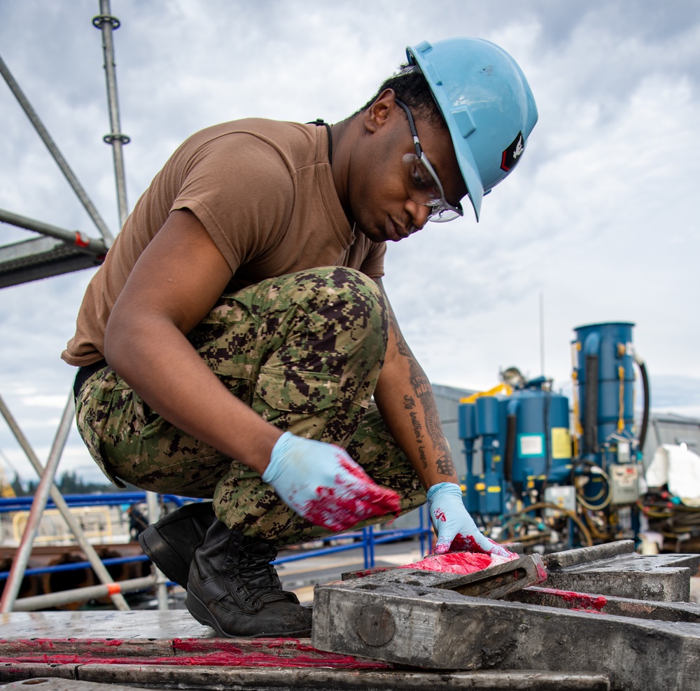 Sailor Applies Lubricant