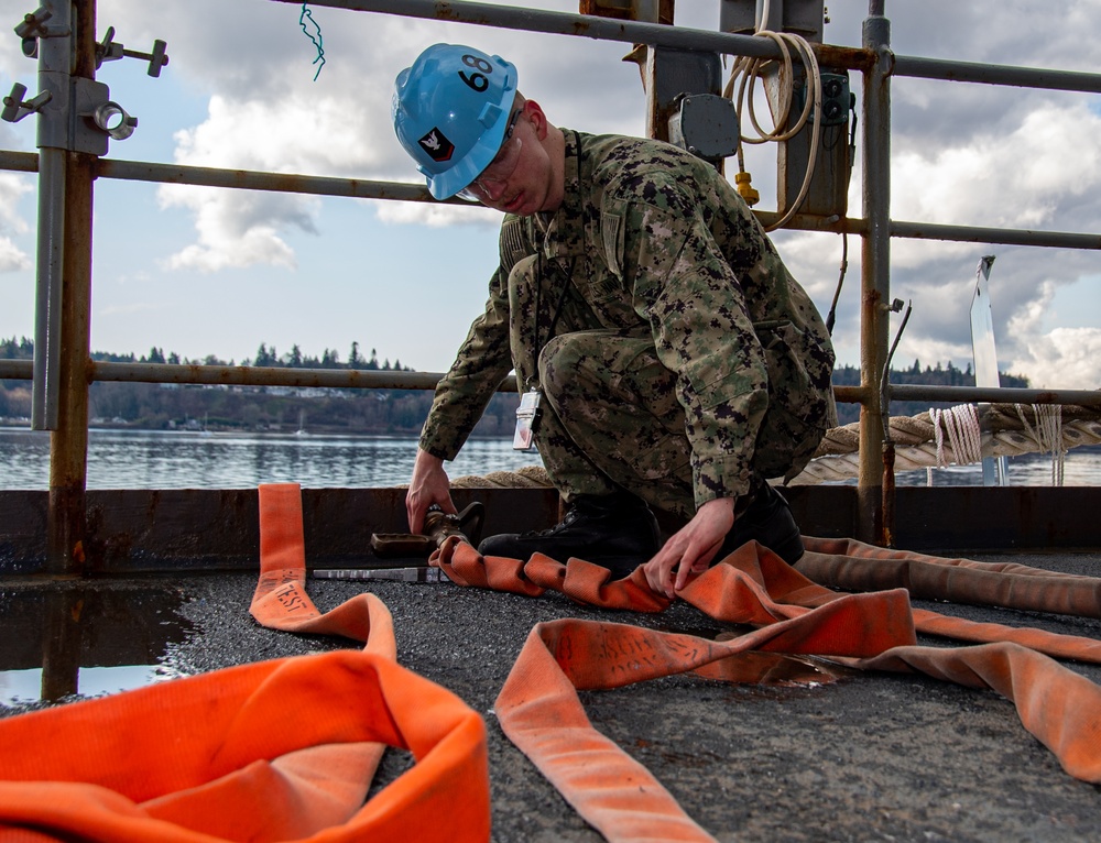 United States Navy Sailor Tests Fire Hose