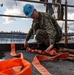 United States Navy Sailor Tests Fire Hose