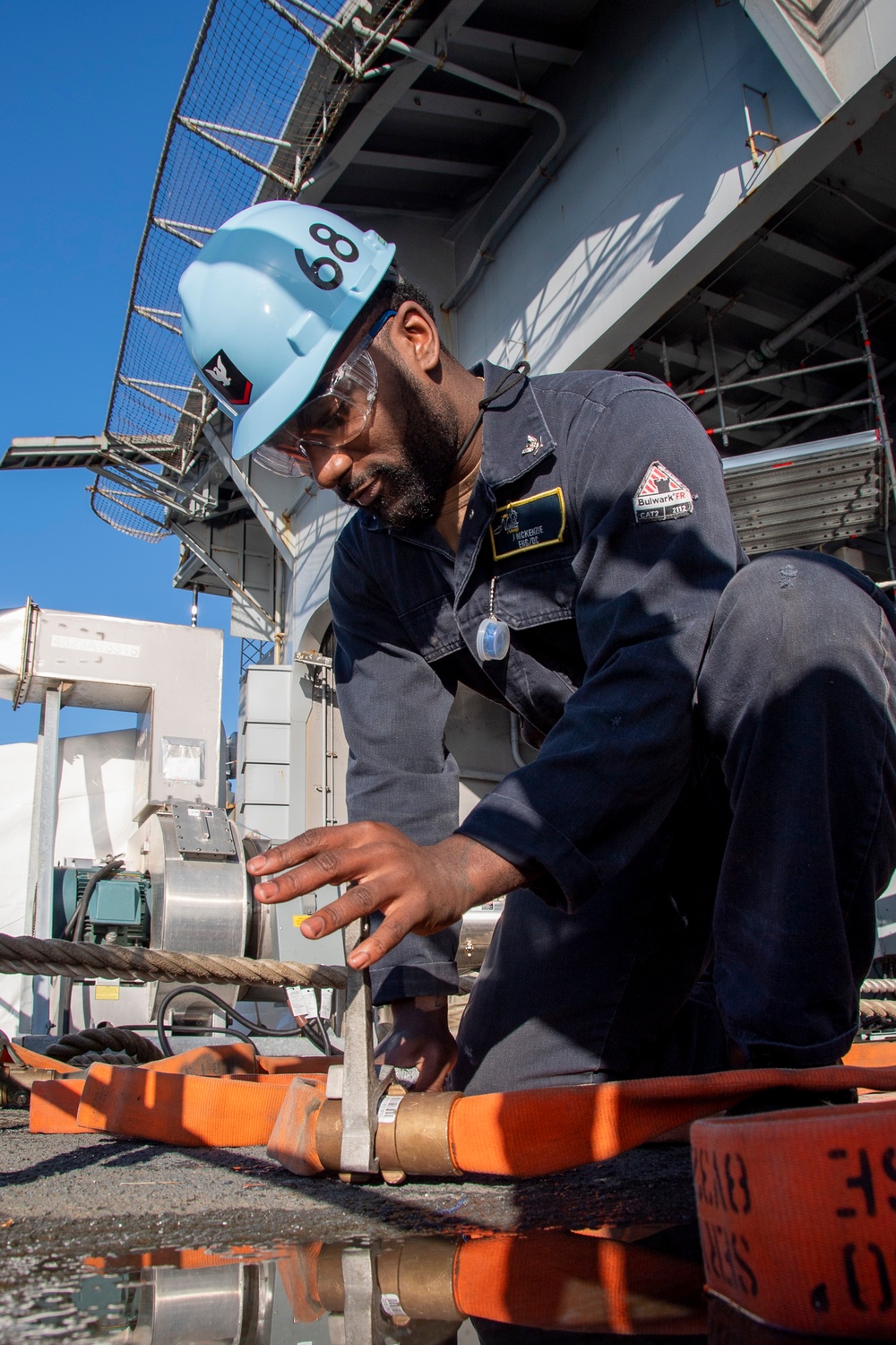 Sailor Tightens Hose Covering