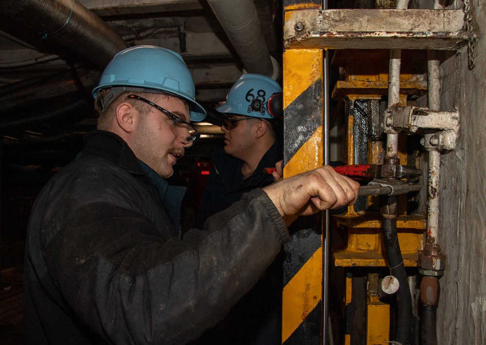 Sailors Remove Elevator Hoses