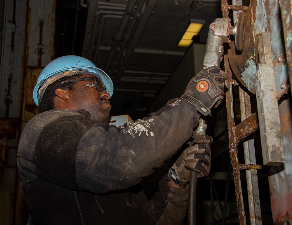 Sailor Conducts Corrosion Control Maintenance