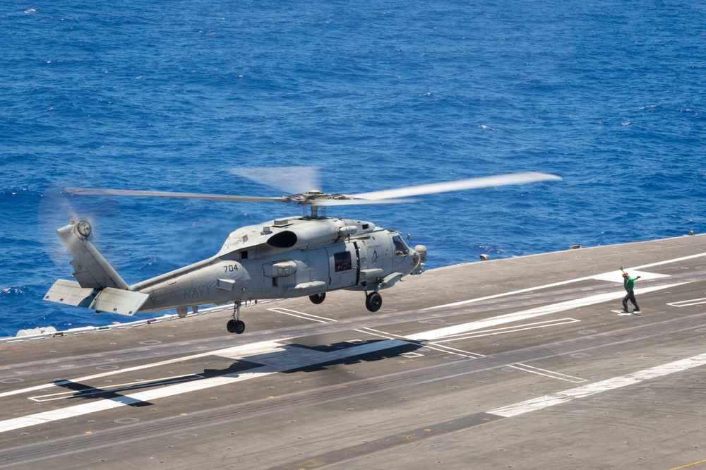 An MH-60R Sea Hawk lands on the flight deck of Nimitz-class aircraft carrier USS Carl Vinson (CVN 70)
