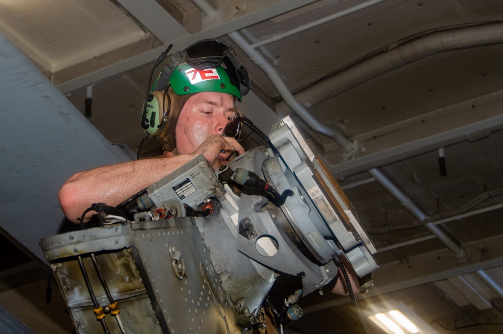 USS Ronald Reagan (CVN 76) Sailors perform maintenance on helicopters