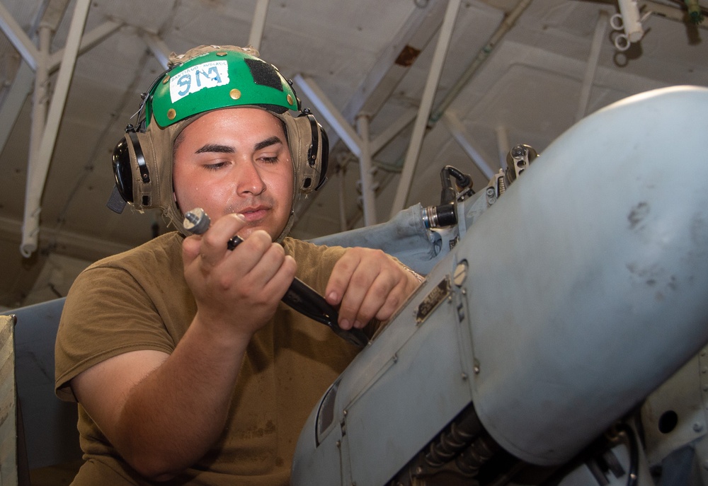 USS Ronald Reagan (CVN 76) Sailors perform maintenance on helicopters