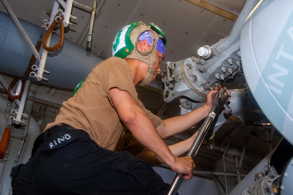 USS Ronald Reagan (CVN 76) Sailors perform maintenance on helicopters