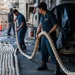 Sailors Handle Mooring Lines