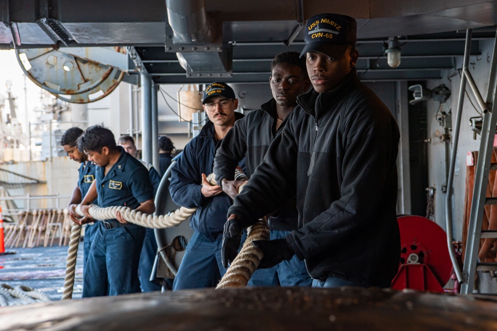 Sailors Handle Mooring Lines