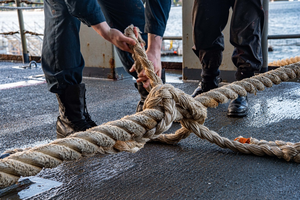 Sailor Handles A Mooring Line