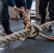 Sailor Handles A Mooring Line