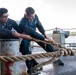 Sailors Handle Mooring Lines