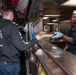 USS Kidd (DDG-100) Sailor Serves Food