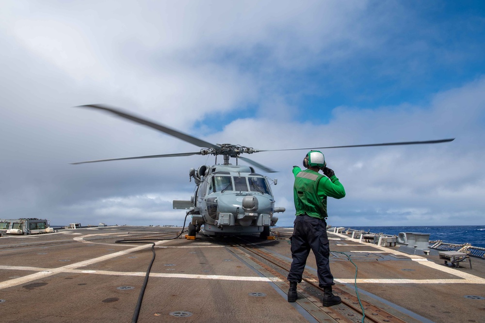 USS Kidd (DDG-100) Sailor Signals Helicopter