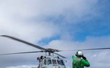 USS Kidd (DDG-100) Sailor Signals Helicopter