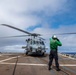 USS Kidd (DDG-100) Sailor Signals Helicopter