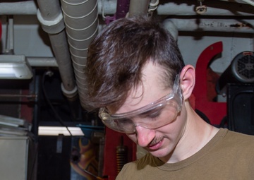 USS Ronald Reagan (CVN 76) Sailors repair equipment