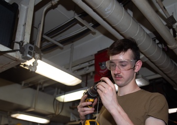 USS Ronald Reagan (CVN 76) Sailors repair equipment