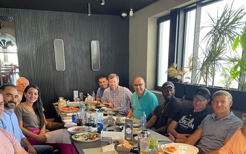 Capt. Pitsenberger (first on left) with Jordan area office staff enjoying a meal together.