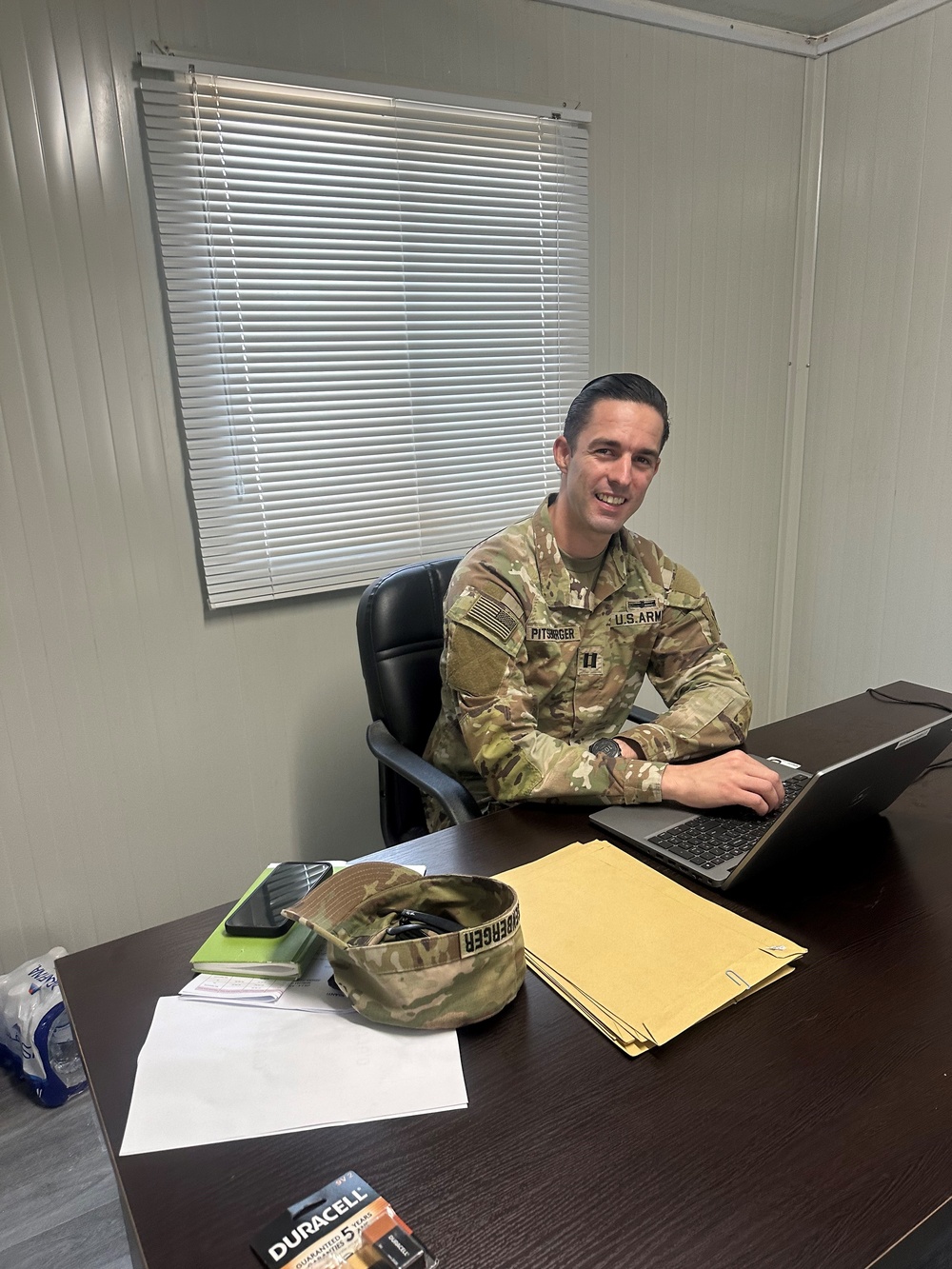 Capt. Andrew Pitsenberger diligently reviews project plans at his desk, ensuring quality and precision in his engineering work.