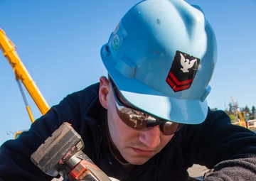 Sailor Performs Maintenance on Catapult Slide Assembly
