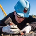 Sailor Performs Maintenance on Catapult Slide Assembly