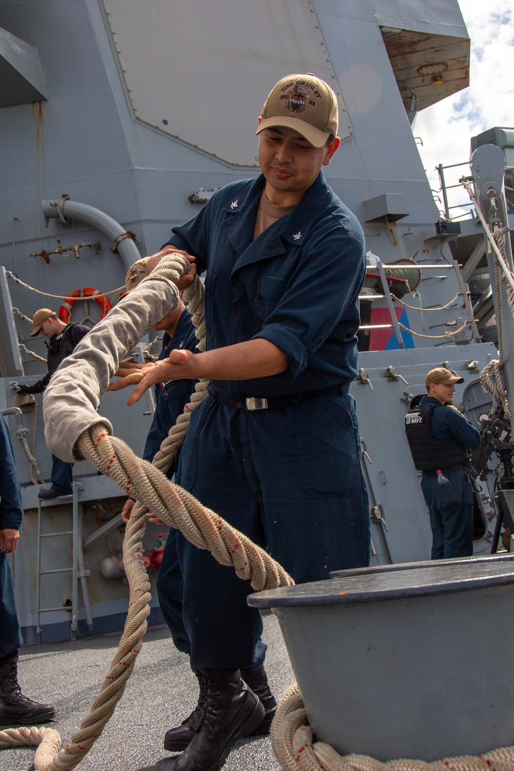 Sailor Removes Line From Chocks