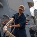 Sailor Removes Line From Chocks