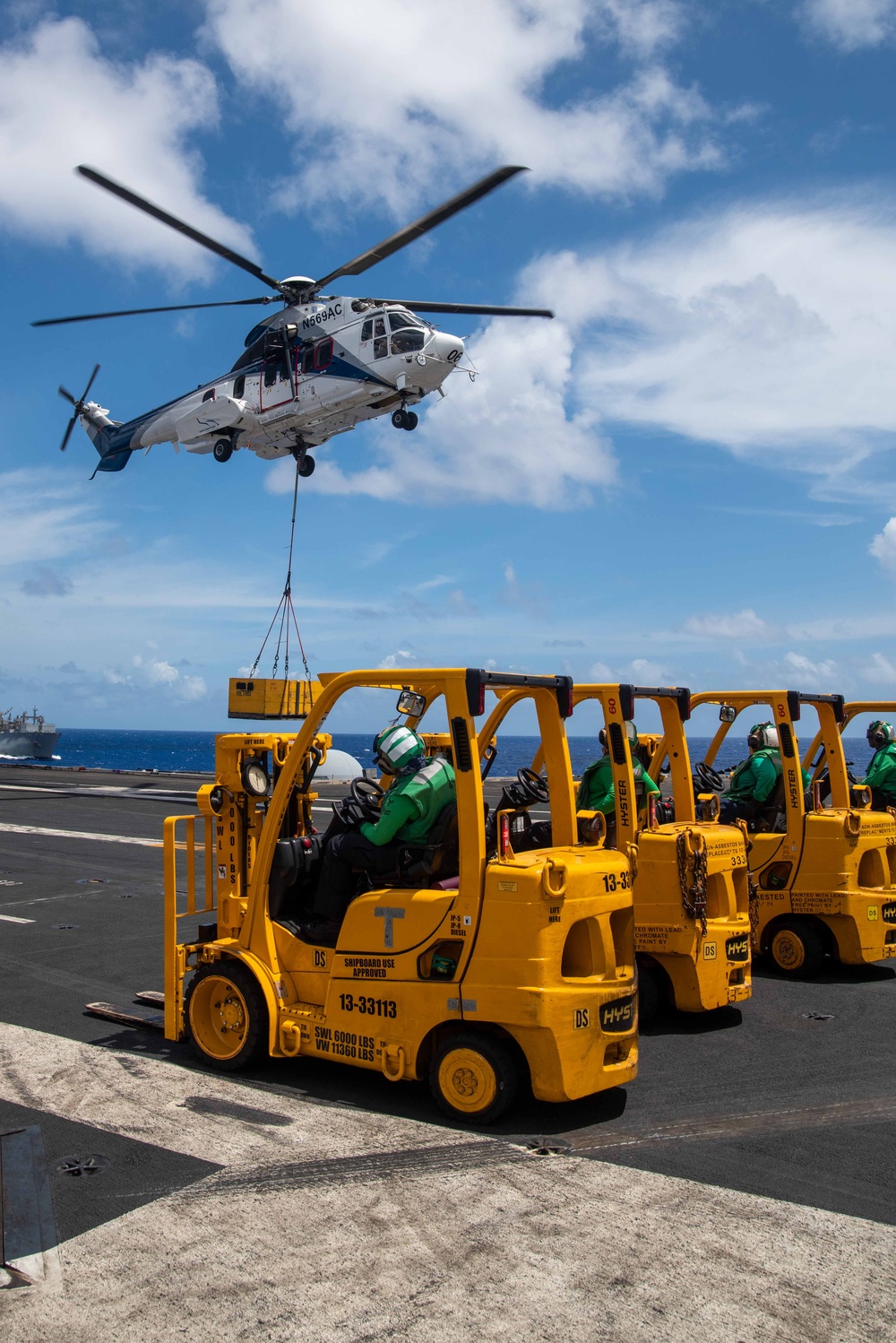 USS Ronald Reagan (CVN 76) conducts a fueling-at-sea and replenishment-at-sea with USNS Rappahannock (T-AO 204) and USNS Cesar Chavez (T-AKE-14)