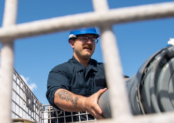 Sailor Offloads Ammunition Canisters