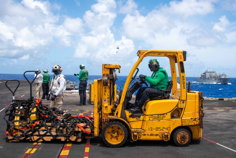 USS Ronald Reagan (CVN 76) conducts a fueling-at-sea and replenishment-at-sea with USNS Rappahannock (T-AO 204) and USNS Cesar Chavez (T-AKE-14)