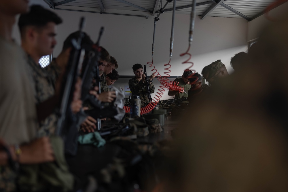 U.S. Marines, French soldiers clean FAMAS rifles during Marara 24