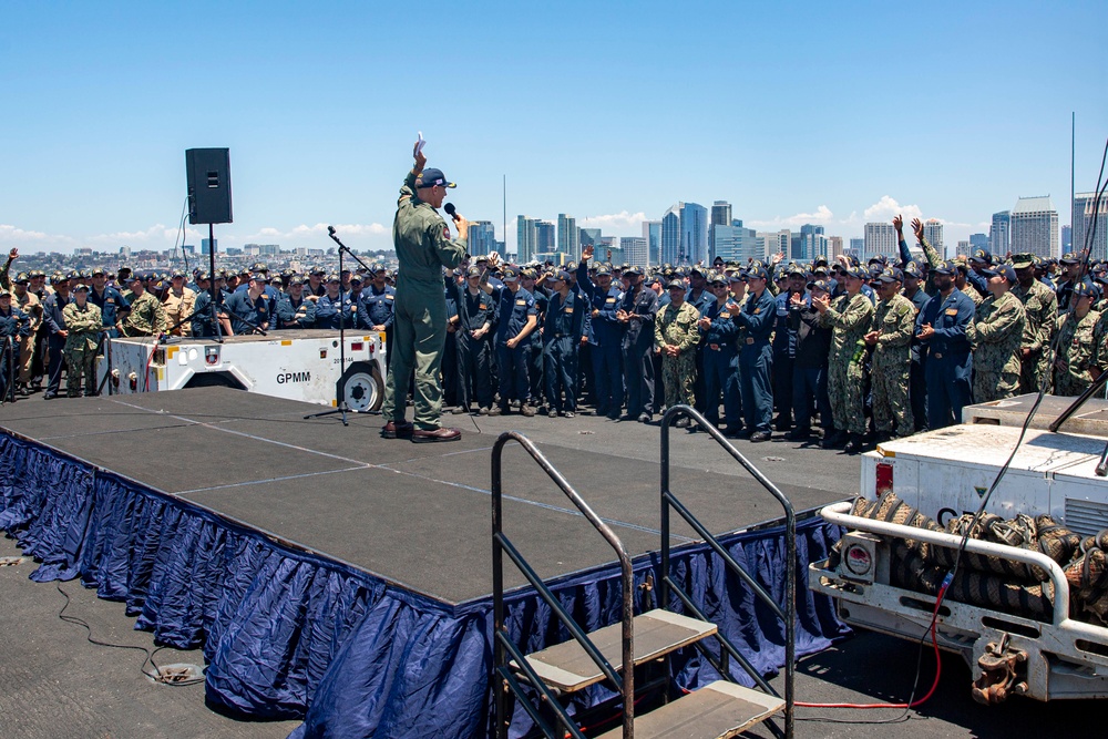 Abraham Lincoln conducts an all-hands call on the flight deck